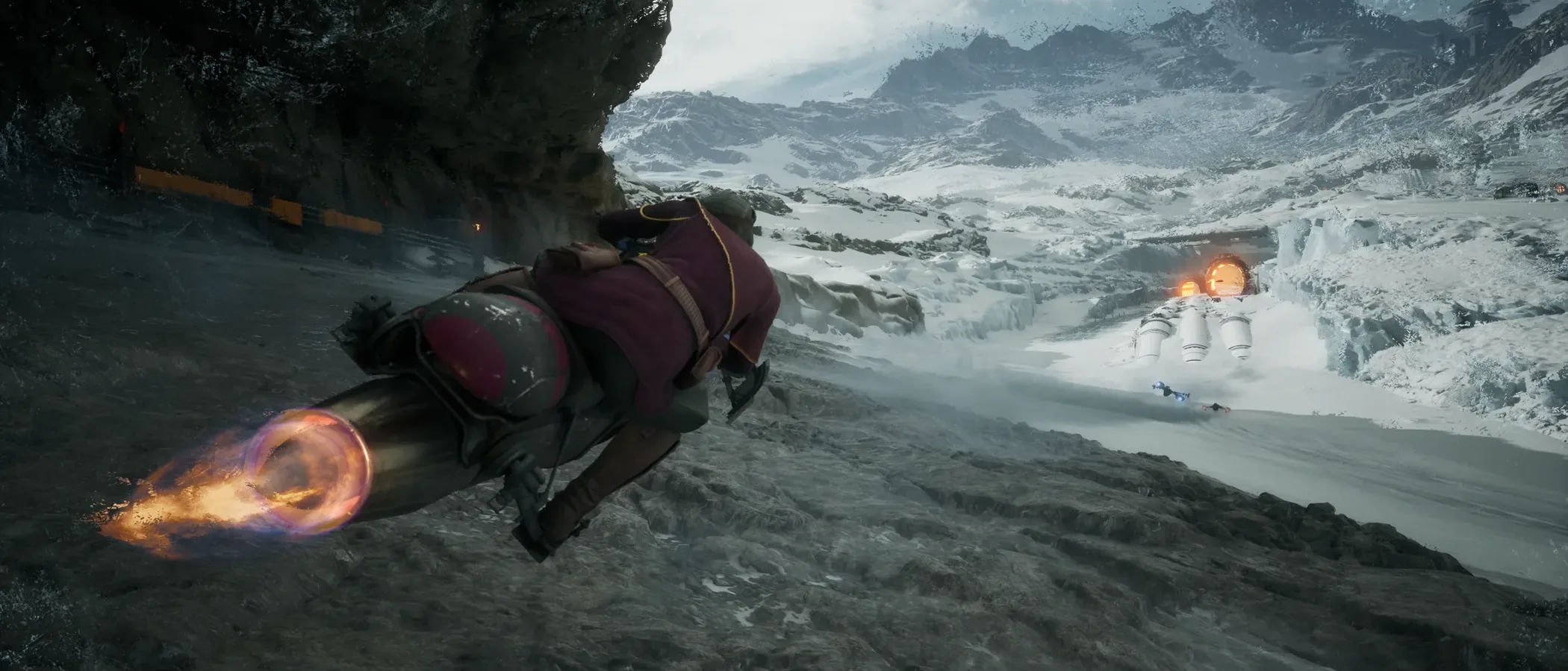A speeder bike leans into a bend across a snowy mountain track