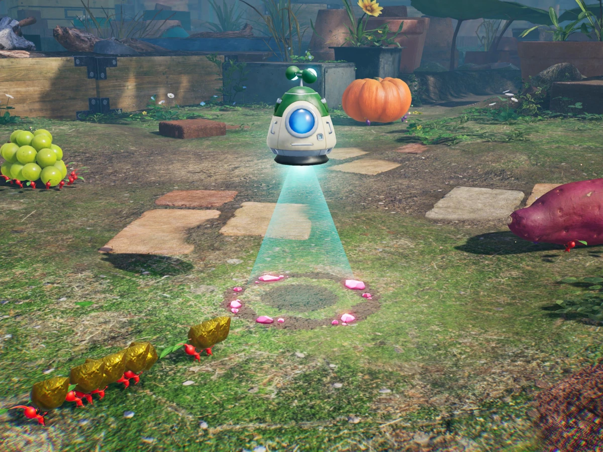 Pikmin carry gold towards a hovering collection pod in a garden dotted with treasure.