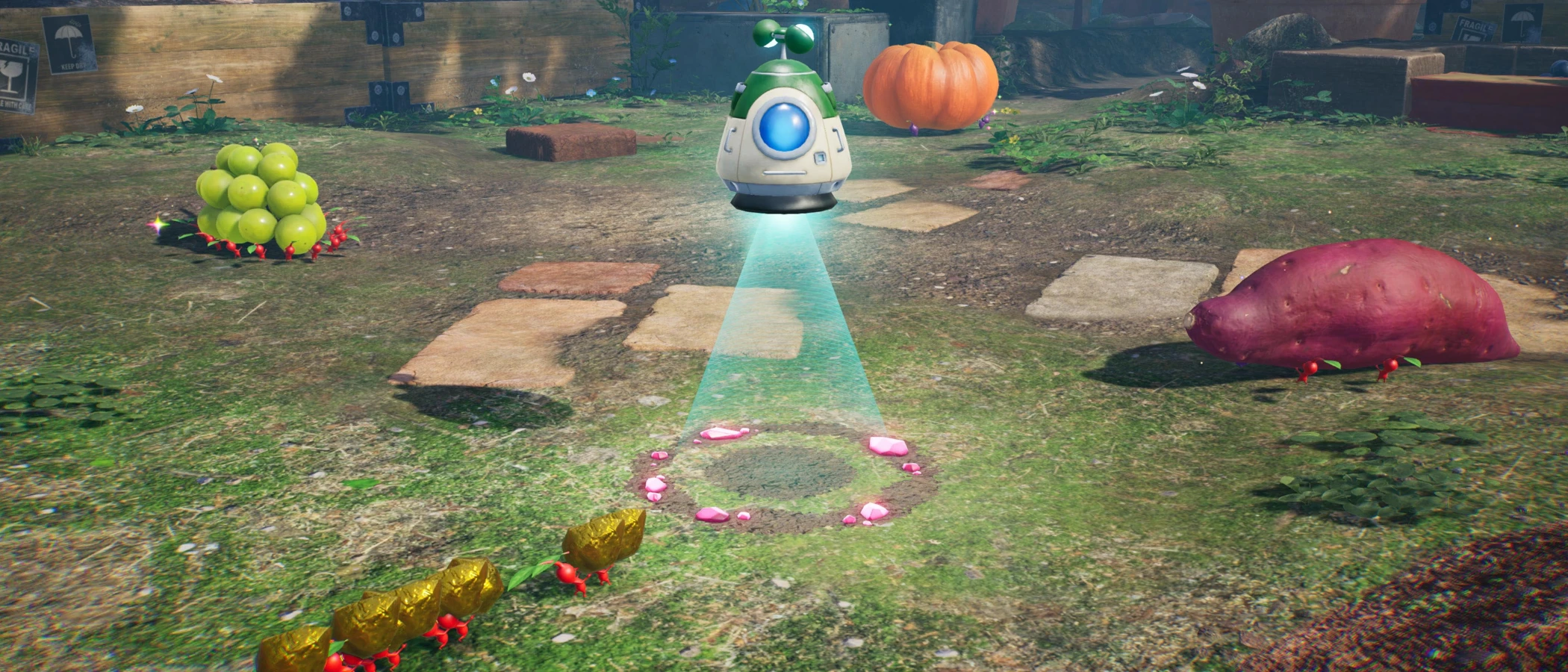 Pikmin carry gold towards a hovering collection pod in a garden dotted with treasure.