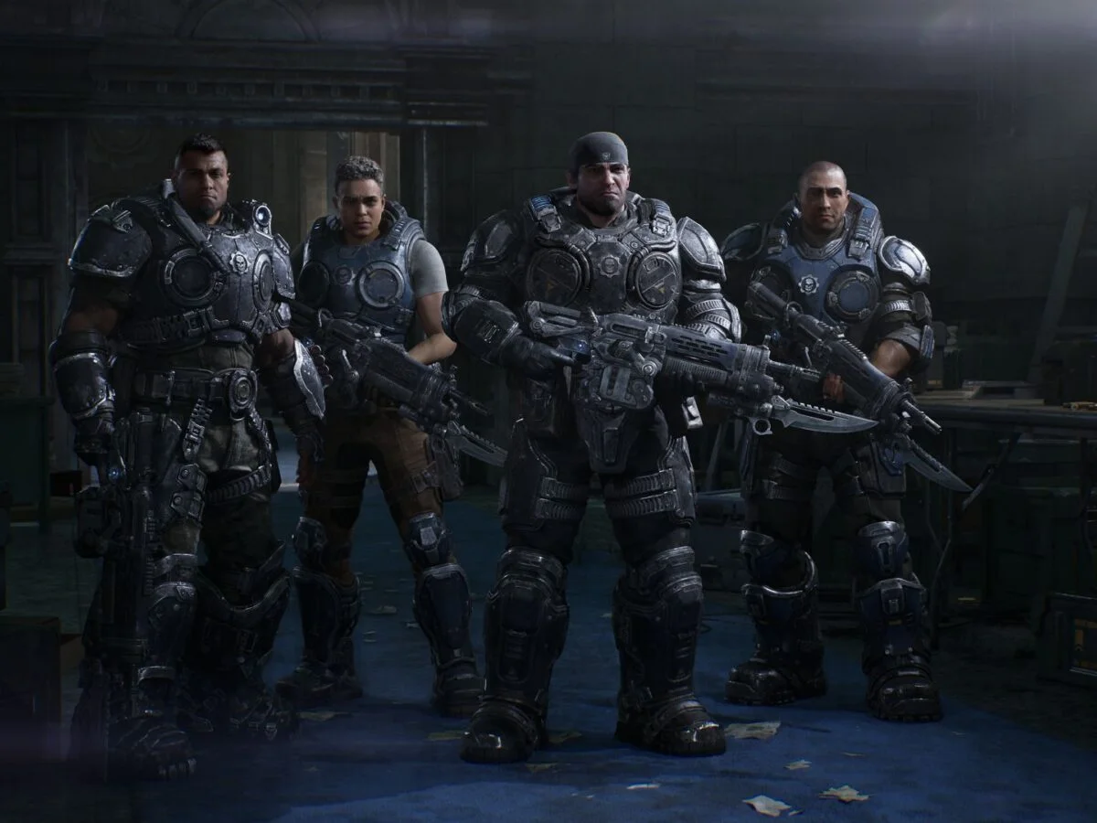 Bravo Squad stands together inside a room in an official Gears of War: E-Day campaign screenshot.