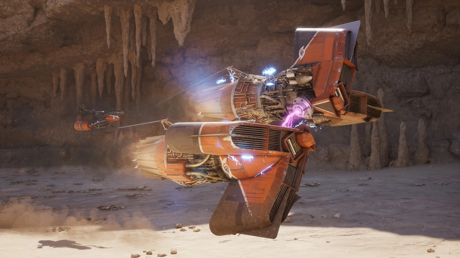 An orange repulsorcraft banks through a cavern with other vehicles behind it