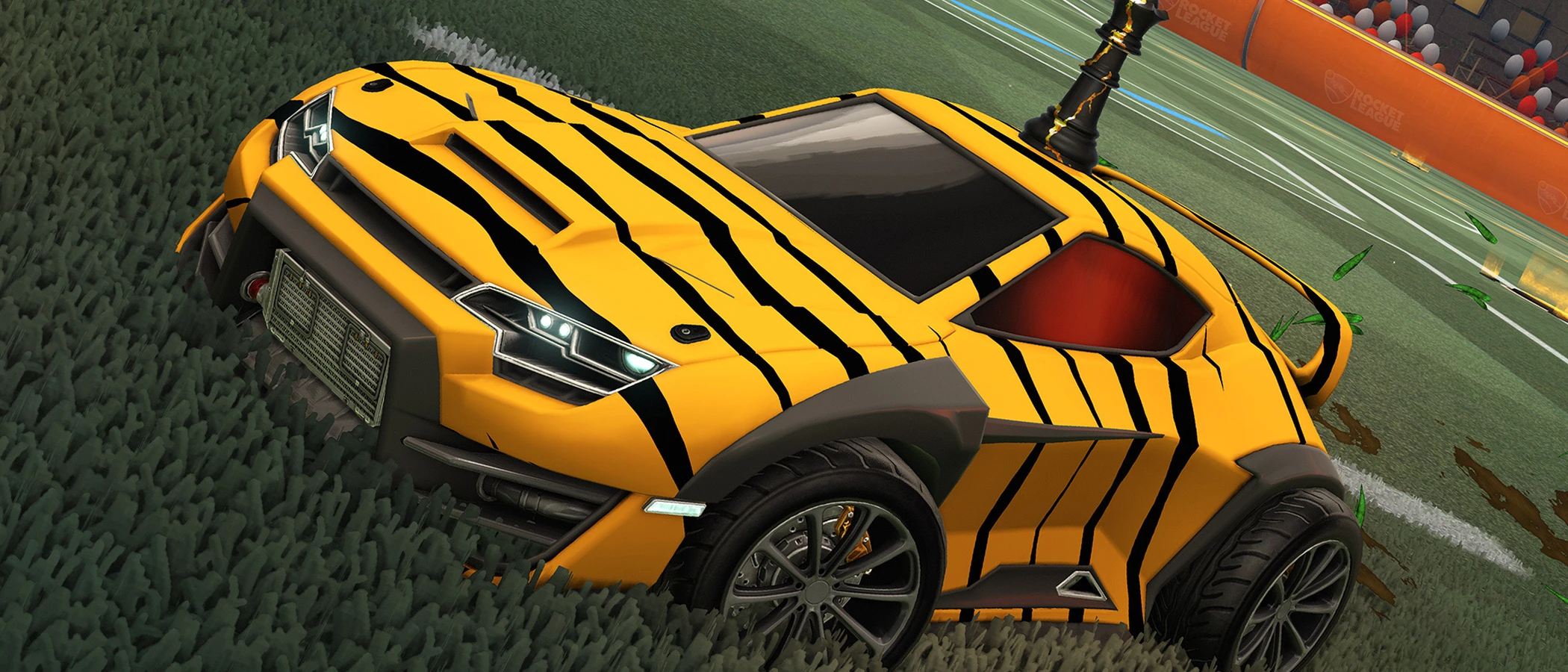 Yellow and black Rocket League car on the pitch in official Season 24 artwork