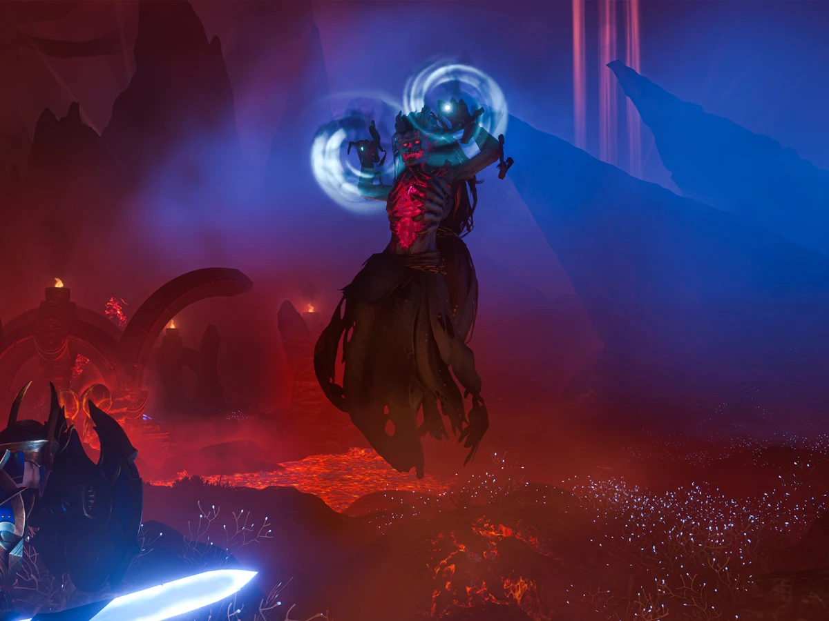 An Enshrouded warrior faces a floating enemy glowing with blue magic.