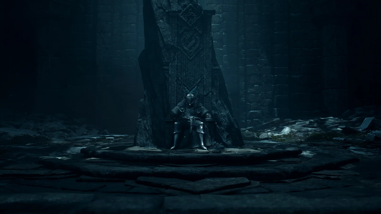 An armoured figure stands inside a dark stone ruin before a tall carved wall.