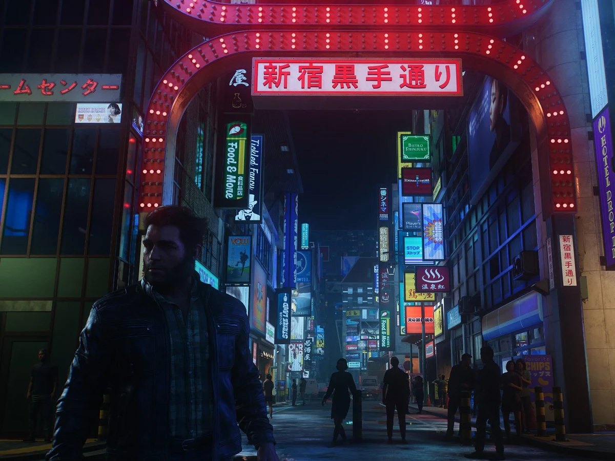 Logan stands beneath an illuminated arch in a neon-lit Shinjuku street in Wolverine.