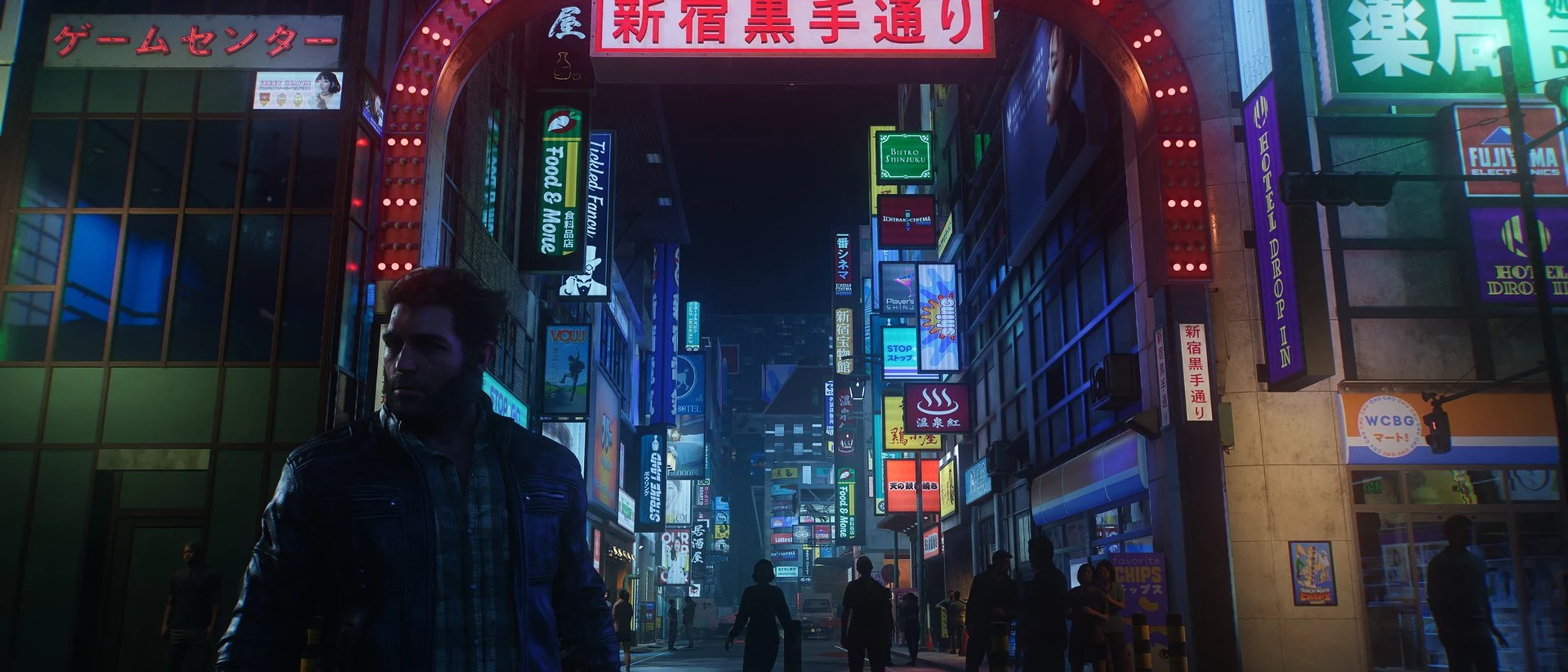 Logan stands beneath an illuminated arch in a neon-lit Shinjuku street in Wolverine.