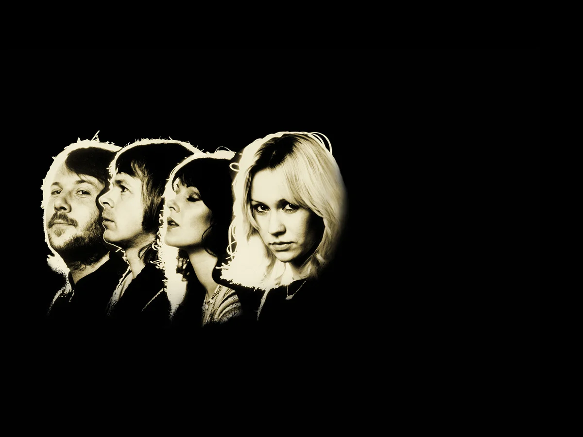 The four members of ABBA in gold-toned portraits against a black background