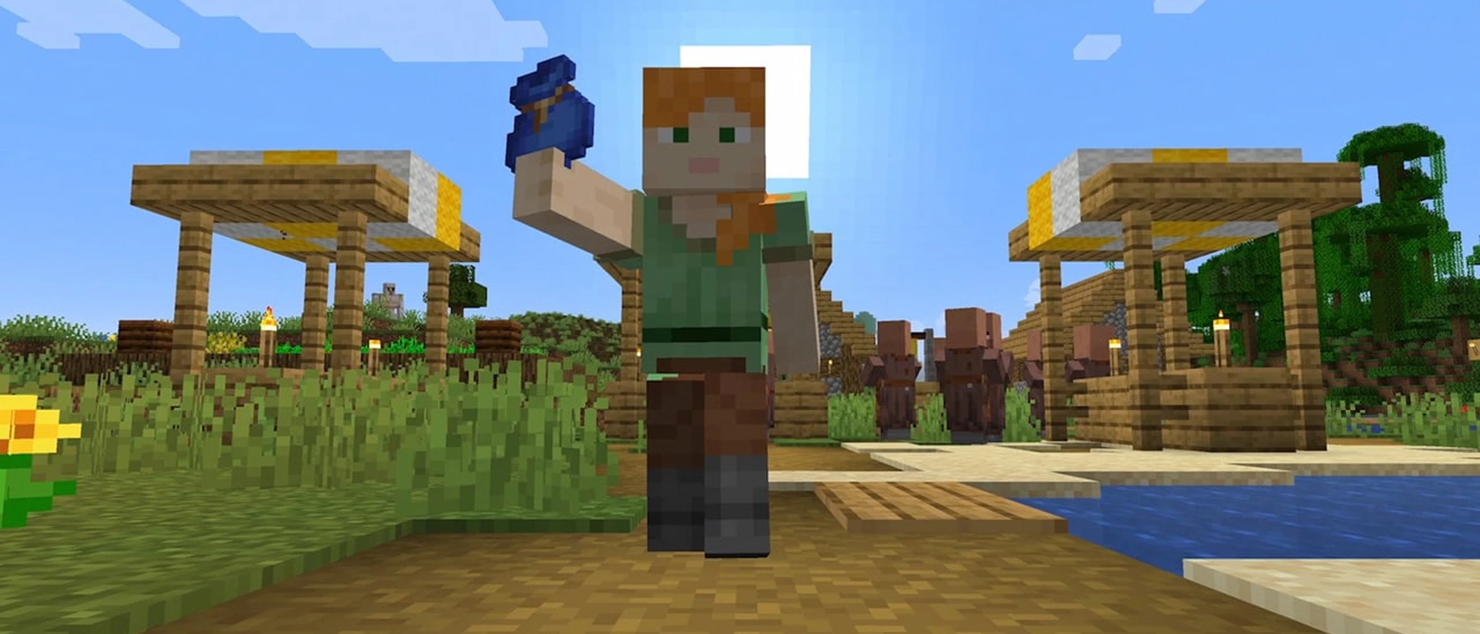 Alex holds up a blue bundle in a Minecraft village beside water