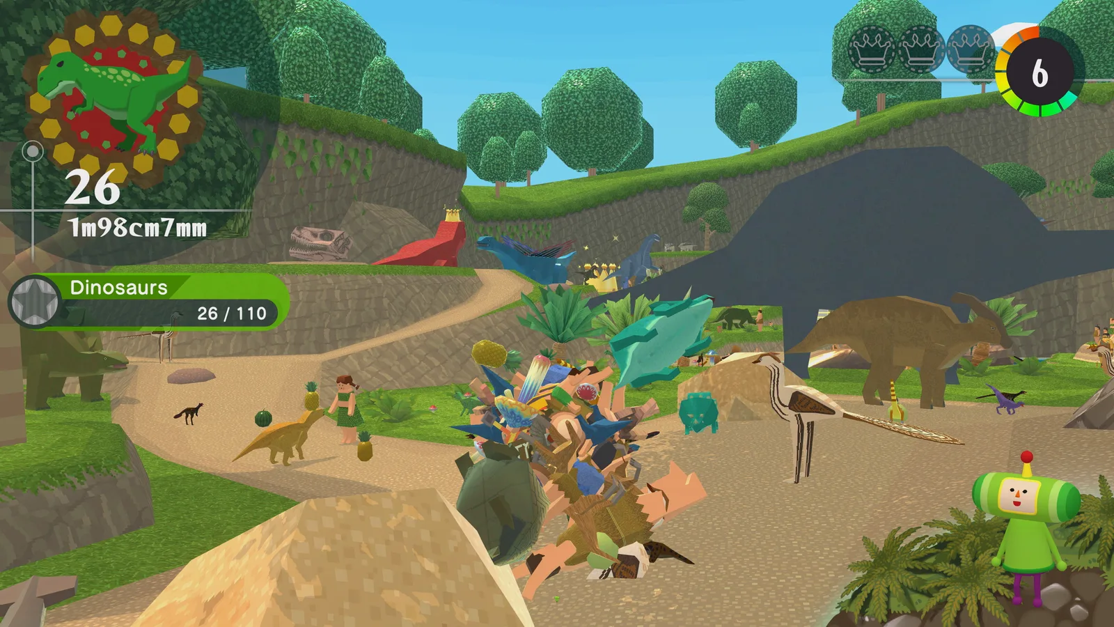 A katamari rolls through a colourful prehistoric landscape with dinosaurs nearby.