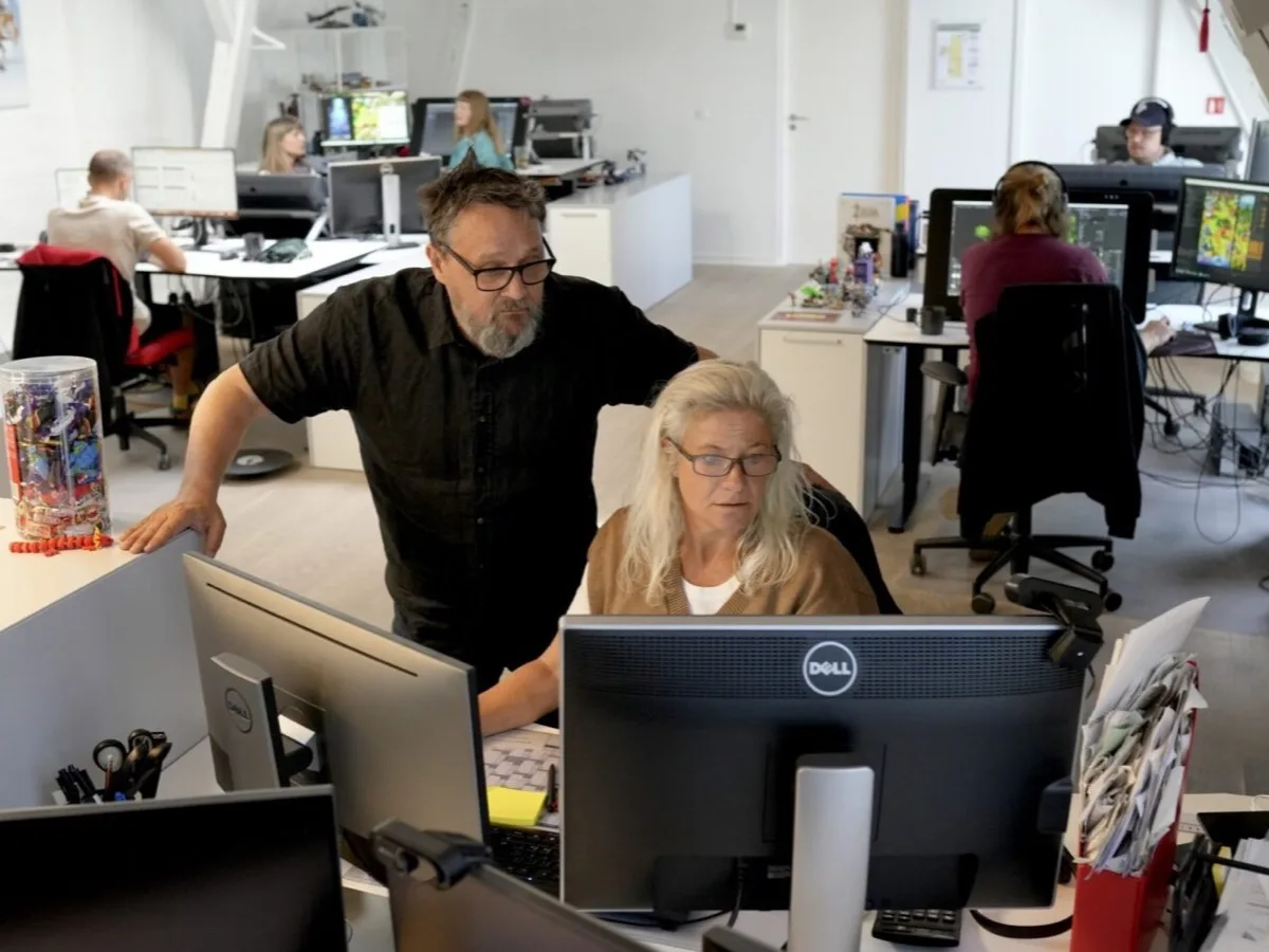 Staff work at computers in an open-plan Rovio Copenhagen office.