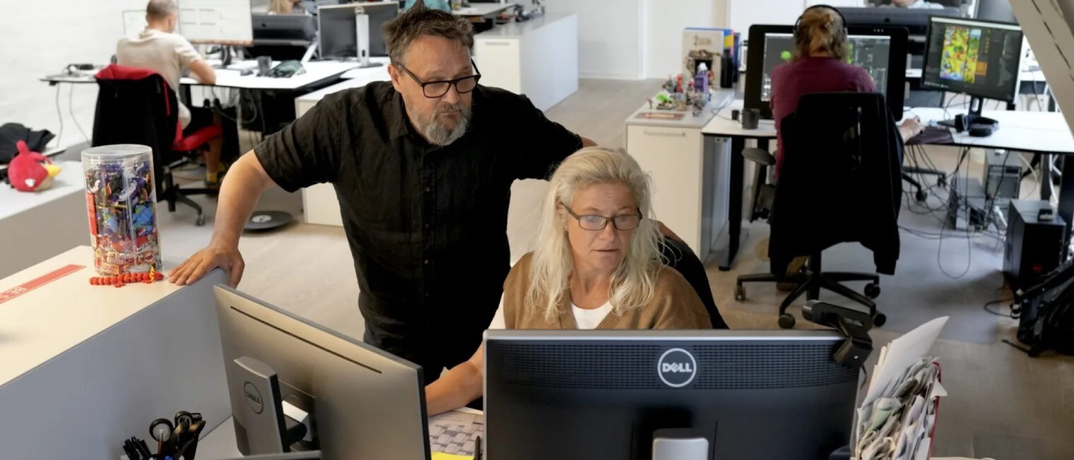 Staff work at computers in an open-plan Rovio Copenhagen office.