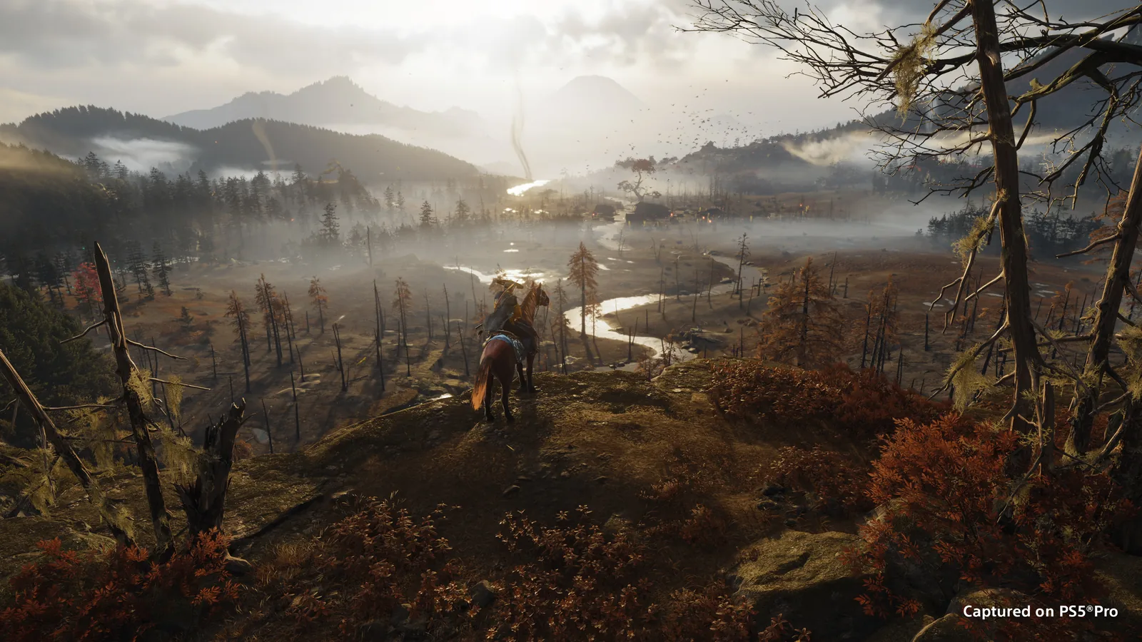 A rider overlooks the scorched Ashoro Foothills in Ghost of Yotei.