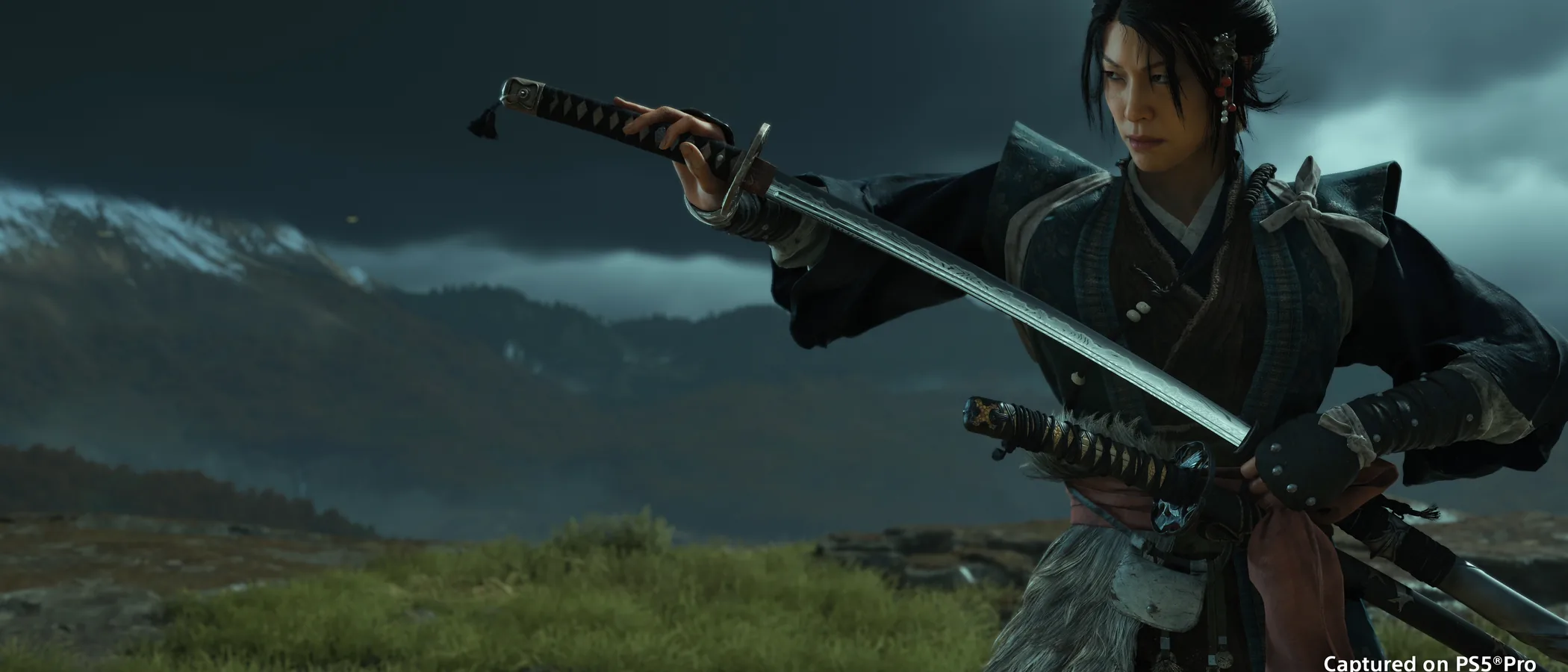 Atsu draws a katana beneath a stormy sky in Ghost of Yotei.