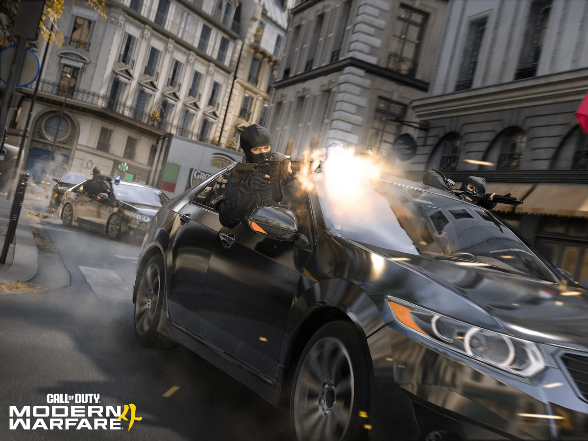 An armed operator leans from a car during a chase through a Paris street in Modern Warfare 4.