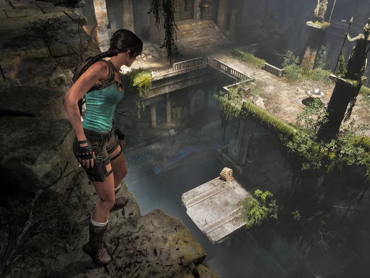 Lara Croft overlooks a vast valley of ancient Greek ruins with towers, statues and distant mountains.