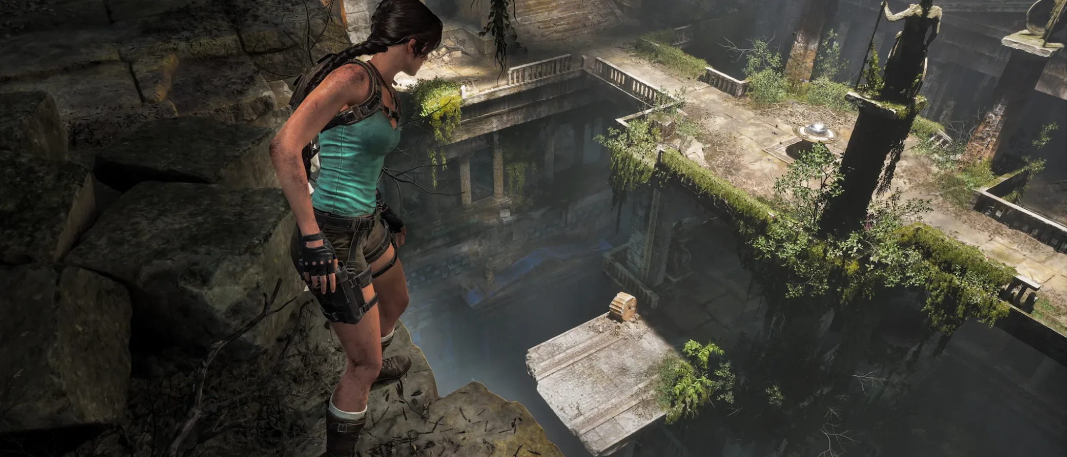 Lara Croft overlooks a vast valley of ancient Greek ruins with towers, statues and distant mountains.