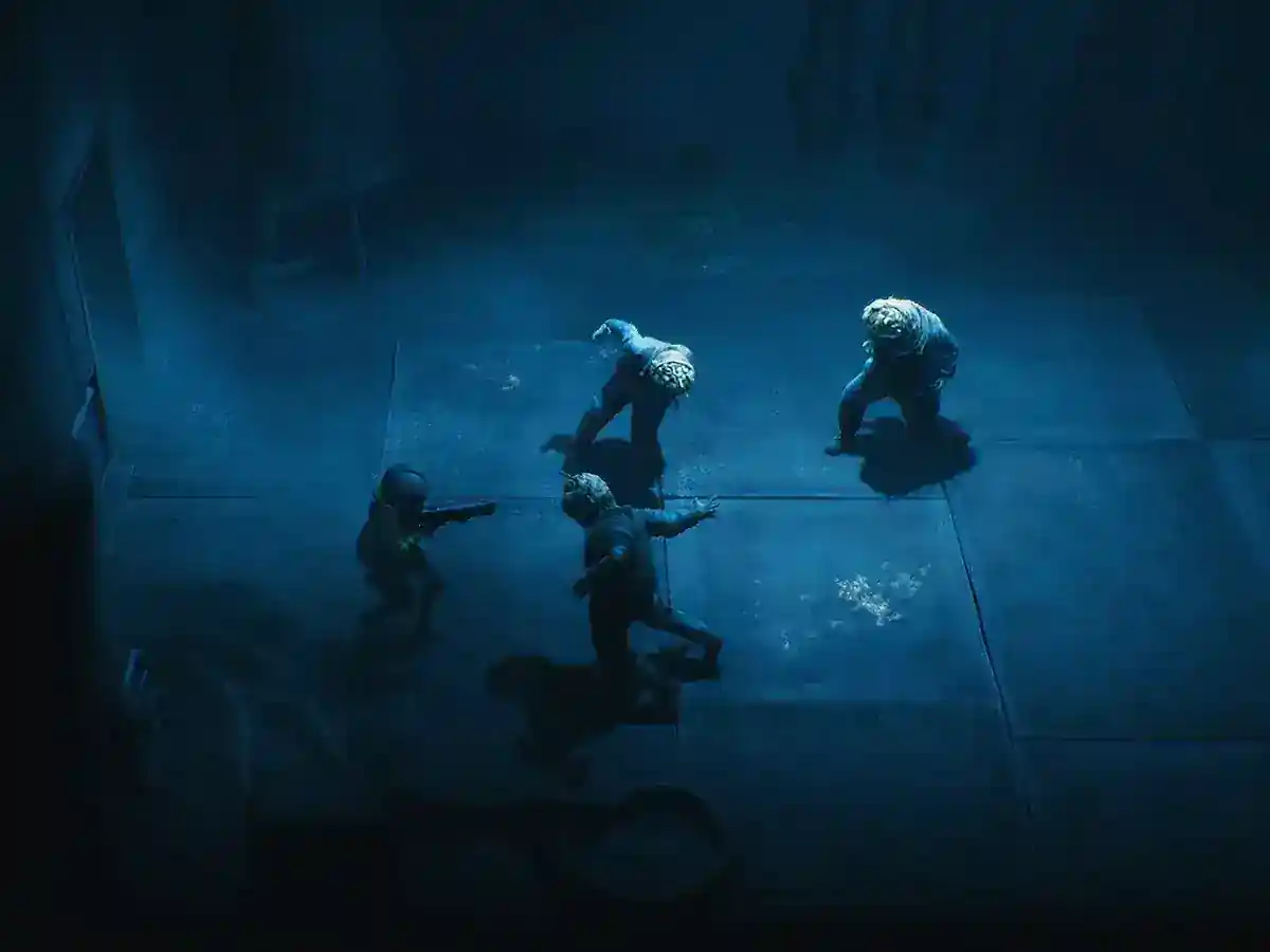 Two small figures face each other in a dark blue industrial chamber.