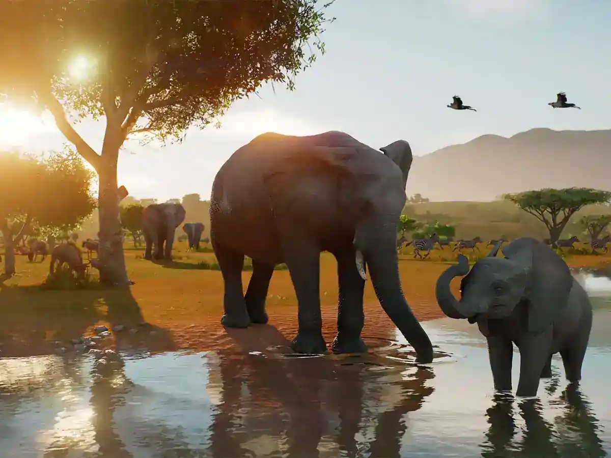 Adult and young elephants stand in a watering hole beside other wildlife.