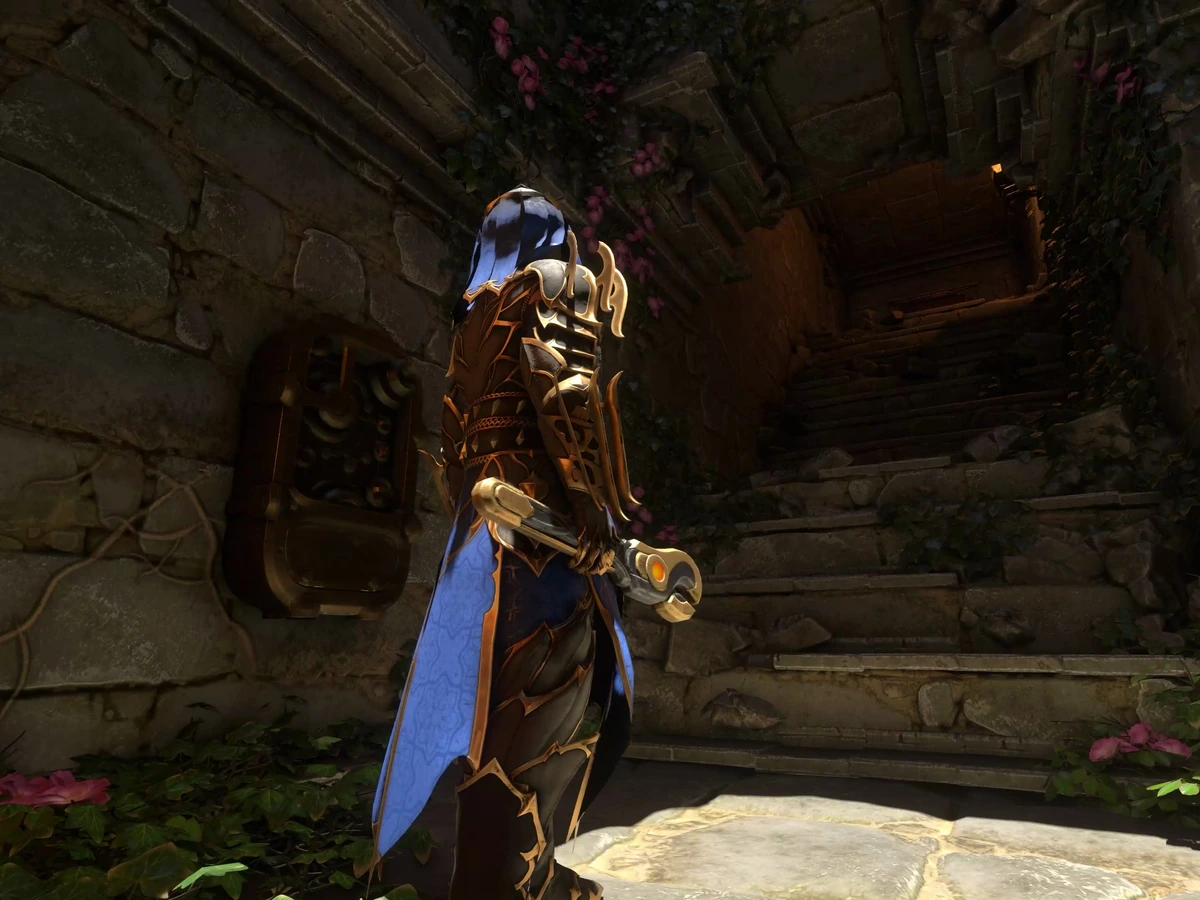 An armoured character holding a tool beside a wall-mounted mechanism and stone stairs in an Enshrouded dungeon.
