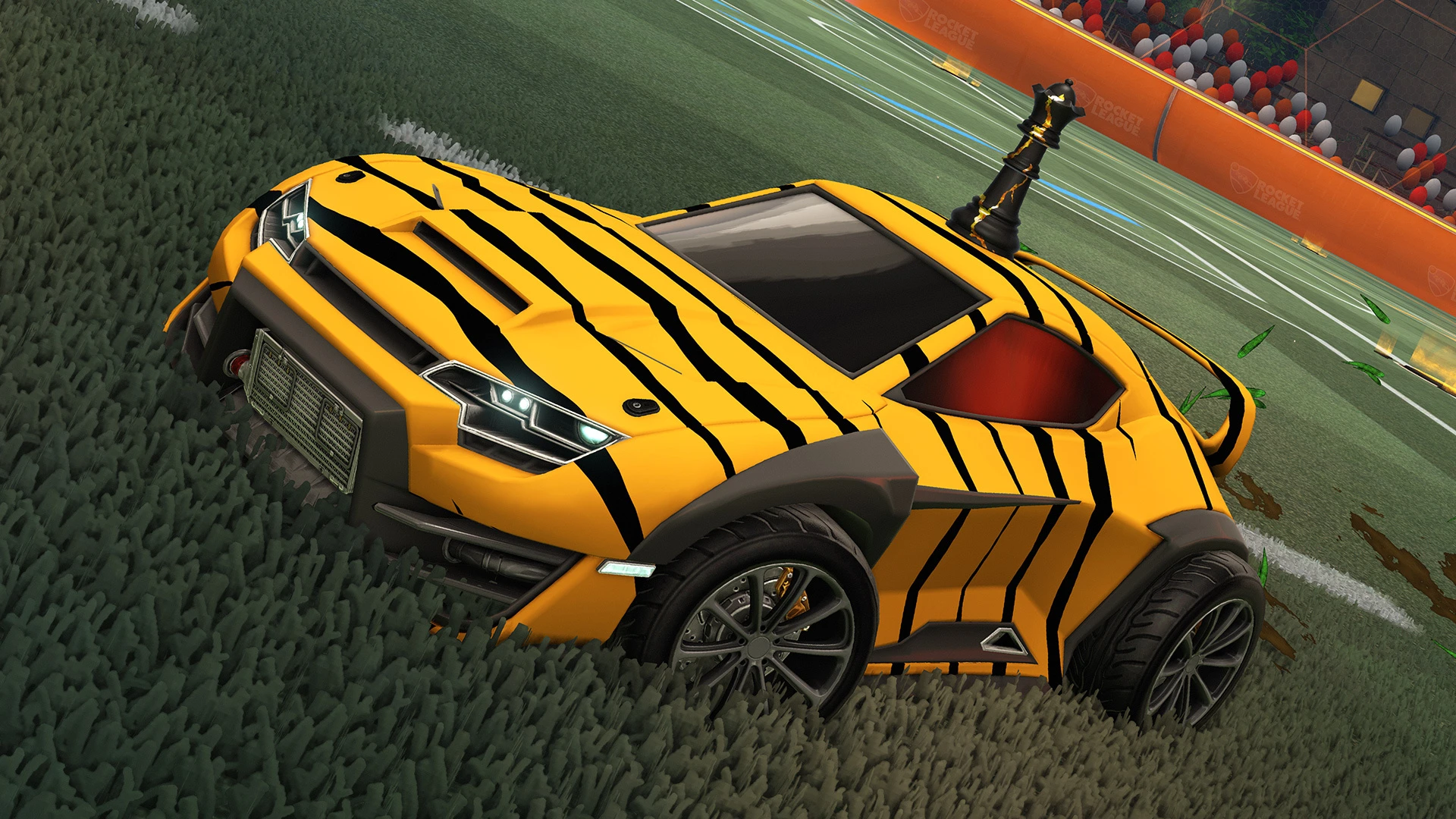 A yellow striped Rocket League car on the grass of an arena