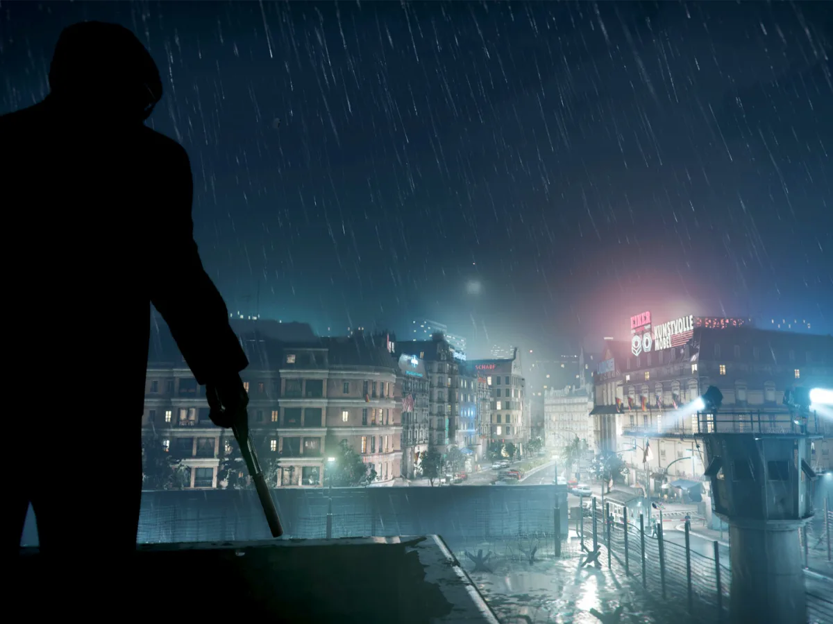 A silhouetted soldier overlooks a rain-soaked, floodlit city at night in Call of Duty: Black Ops Cold War.