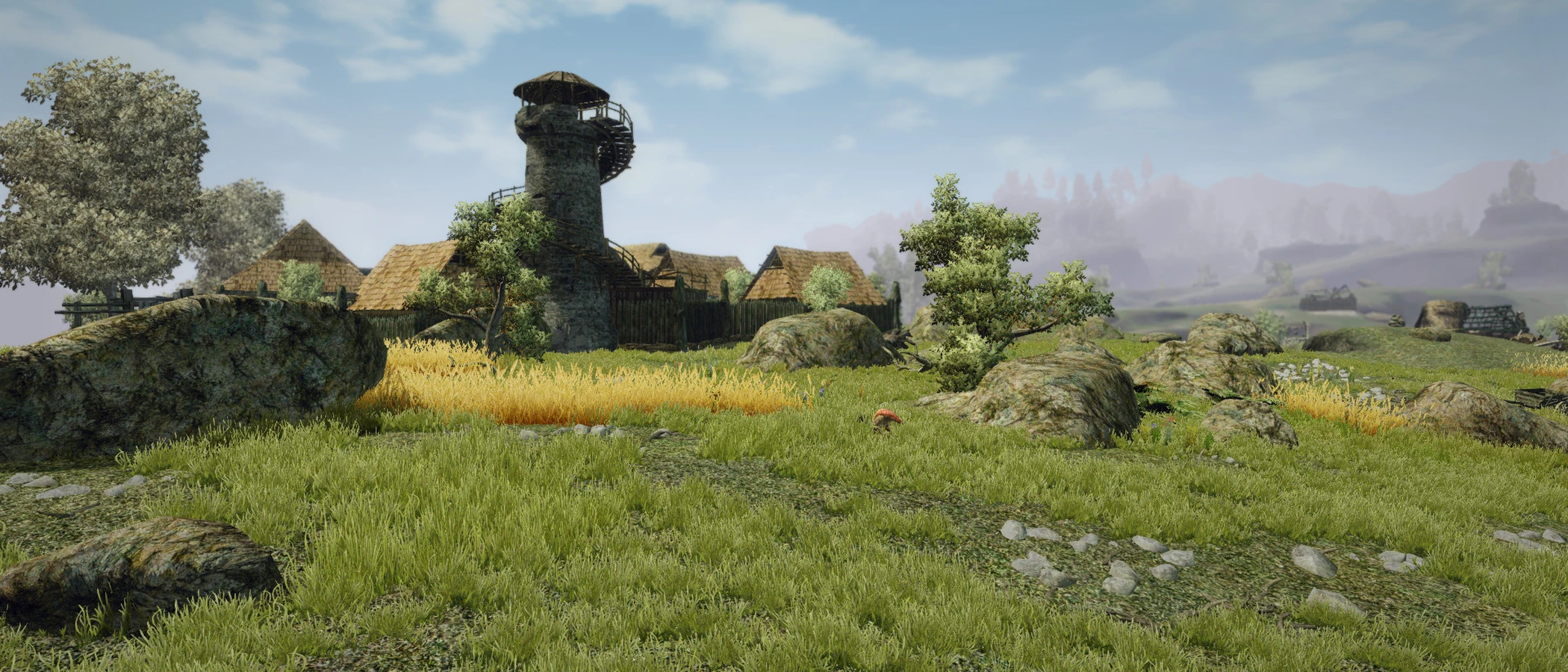 A stone tower and thatched buildings stand beside yellow crops in a green Gothic III landscape.