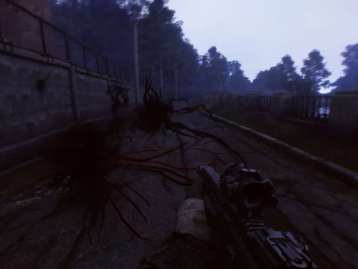 An operative carrying a rifle crosses a ruined outdoor zone in Active Matter.