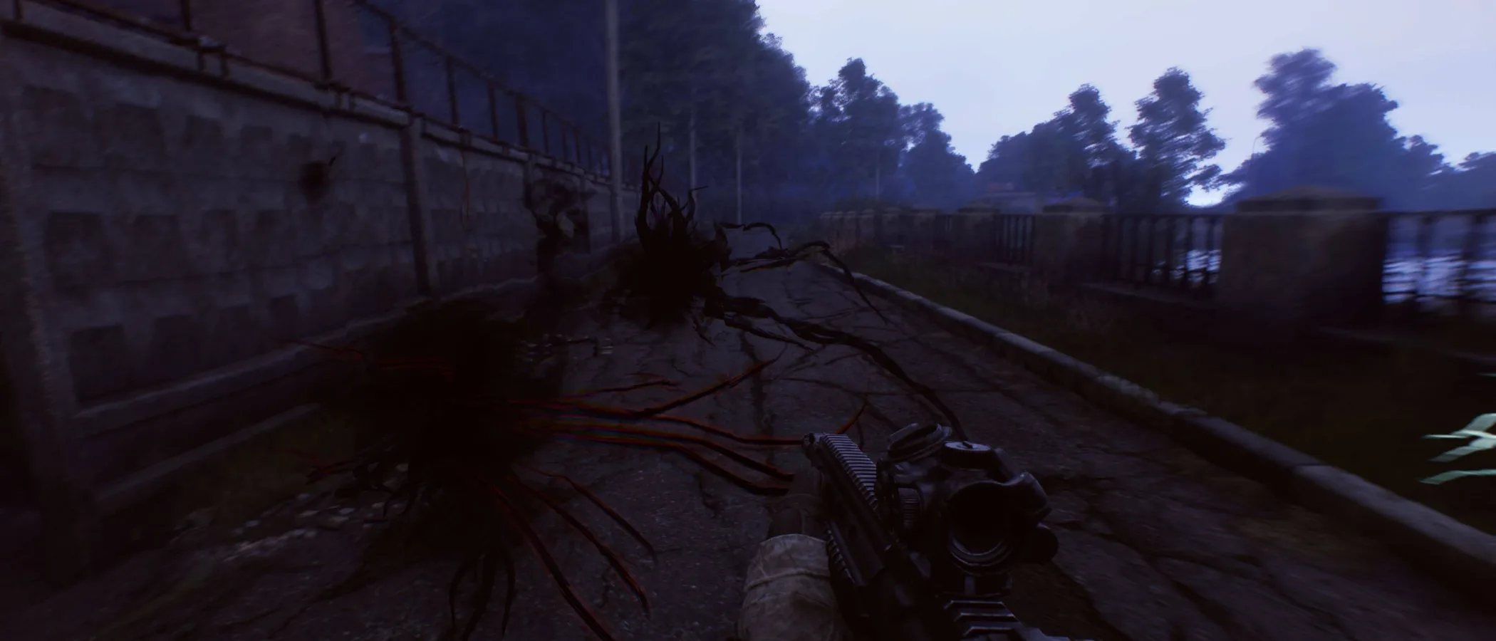 An operative carrying a rifle crosses a ruined outdoor zone in Active Matter.