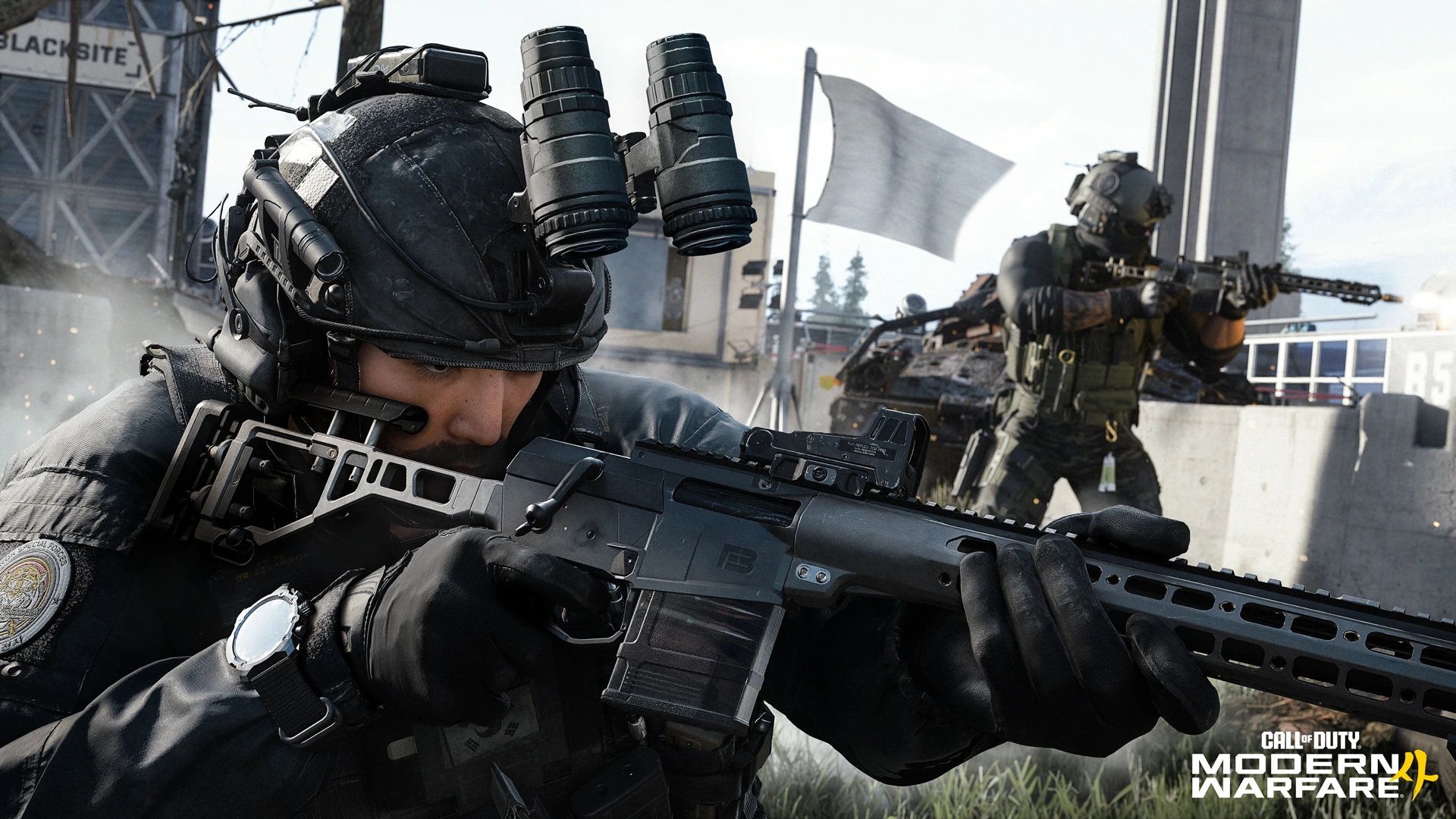 An operator aims a rifle beside training structures marked Blacksite in Kill Block