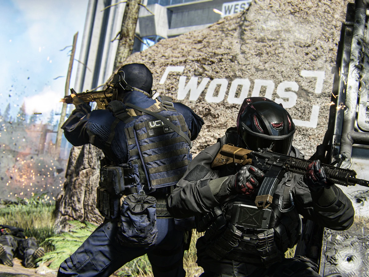 Three armed operators fight beside a wall marked Woods in the Kill Block training facility
