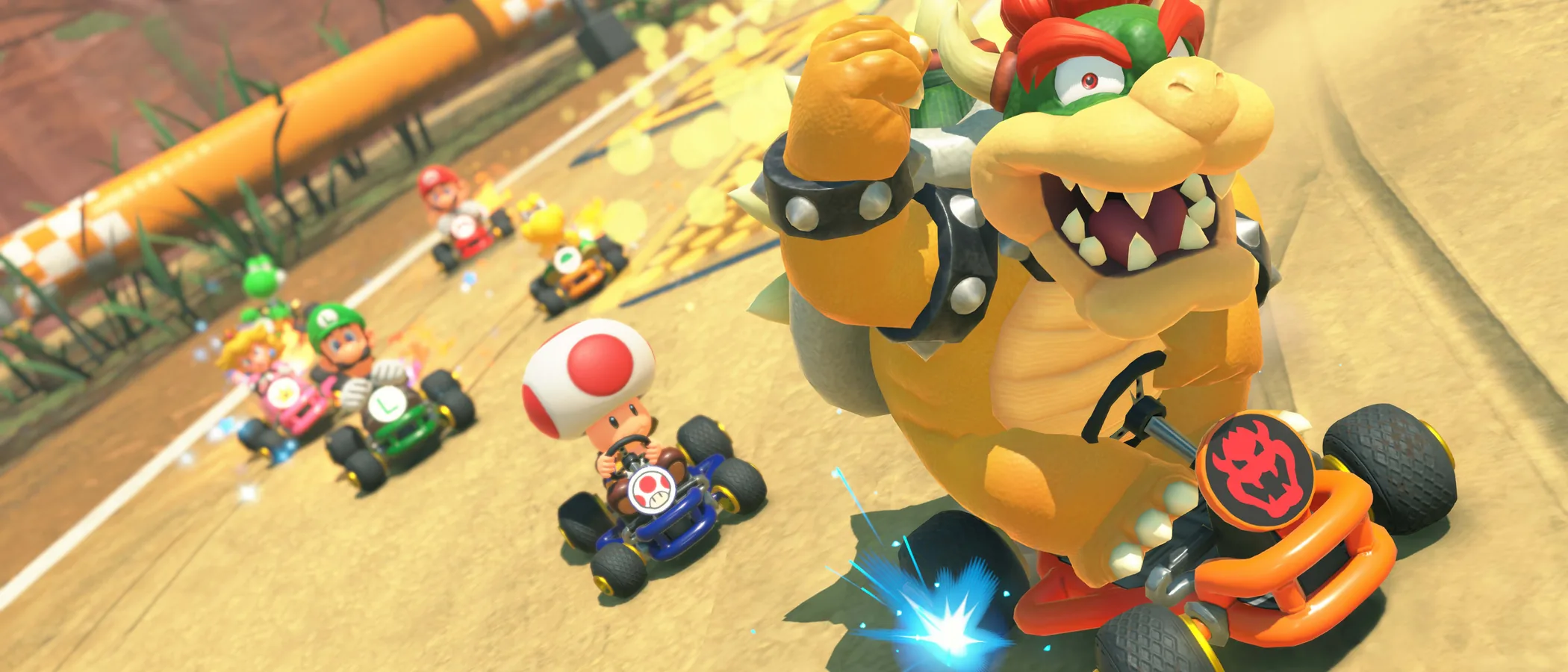 Bowser races through a sandy Super Mario Kart-inspired Choco Island course in Mario Kart World.