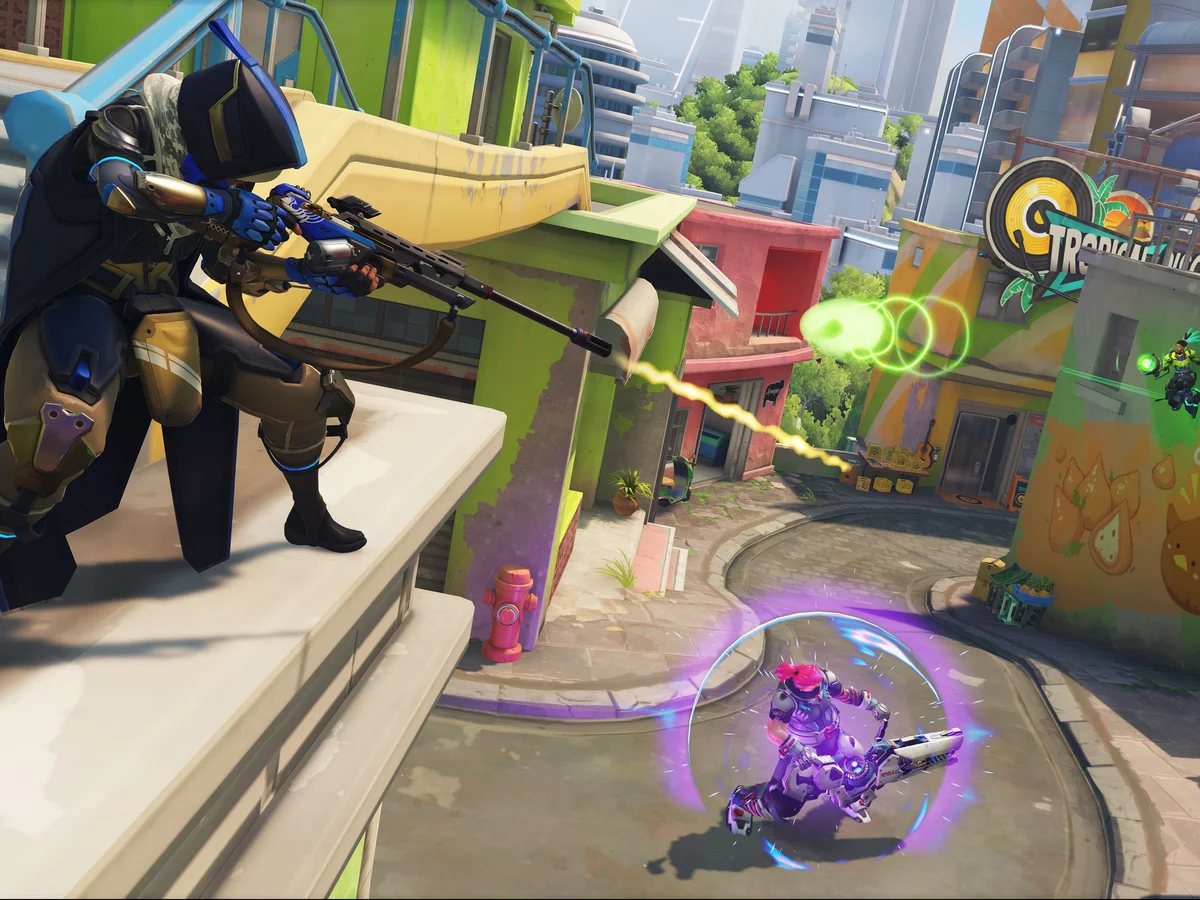 Ana and other Overwatch heroes exchange fire on the streets of Rio.