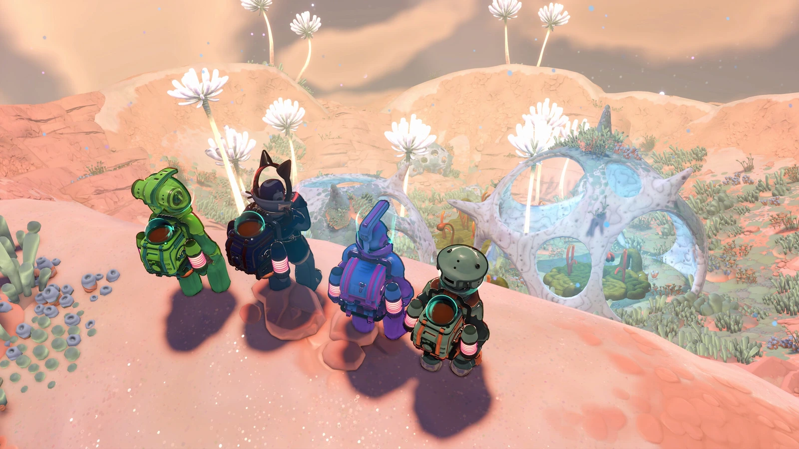 Four suited explorers overlook giant pale plants and an orange moonlet landscape in Young Suns.