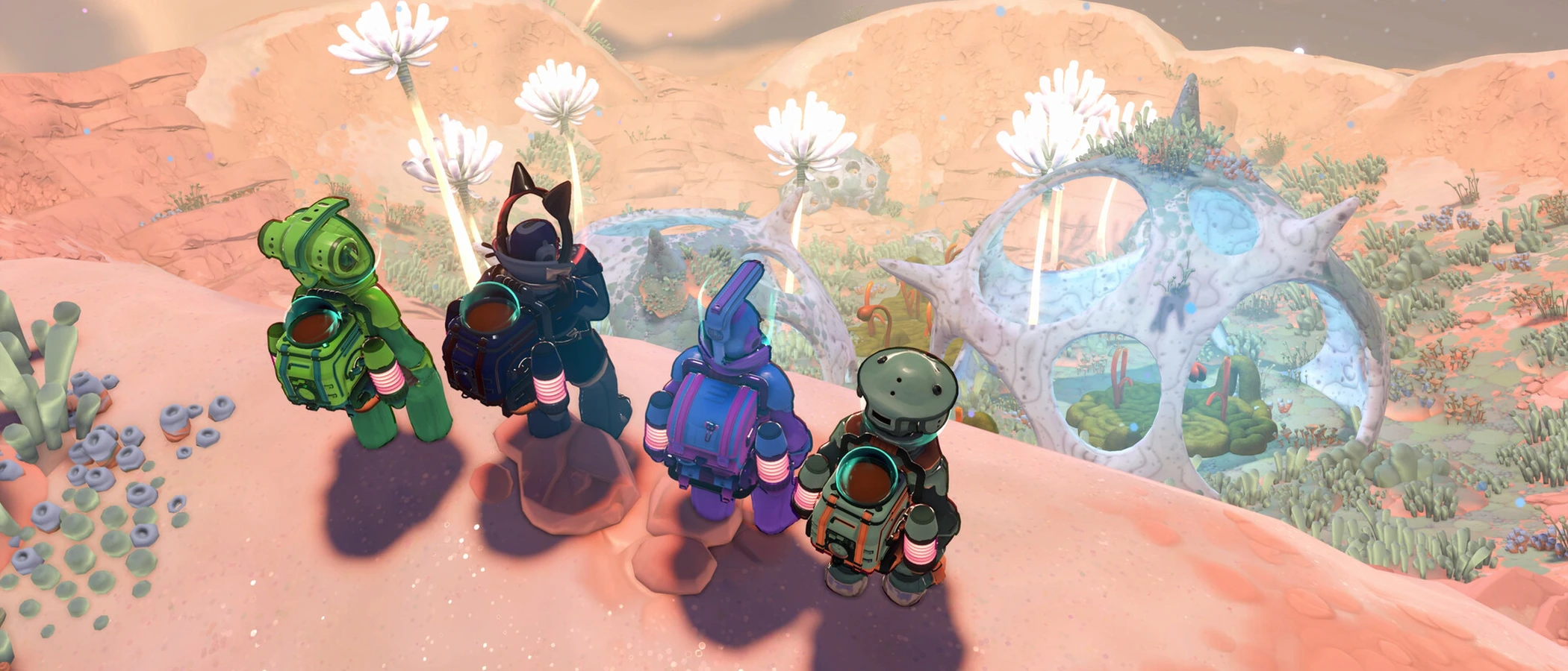 Four suited explorers overlook giant pale plants and an orange moonlet landscape in Young Suns.