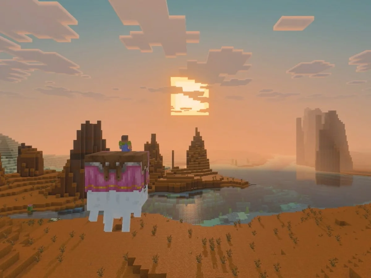 A Minecraft character rides a happy ghast across a sunlit mesa landscape with reflections on the water below.