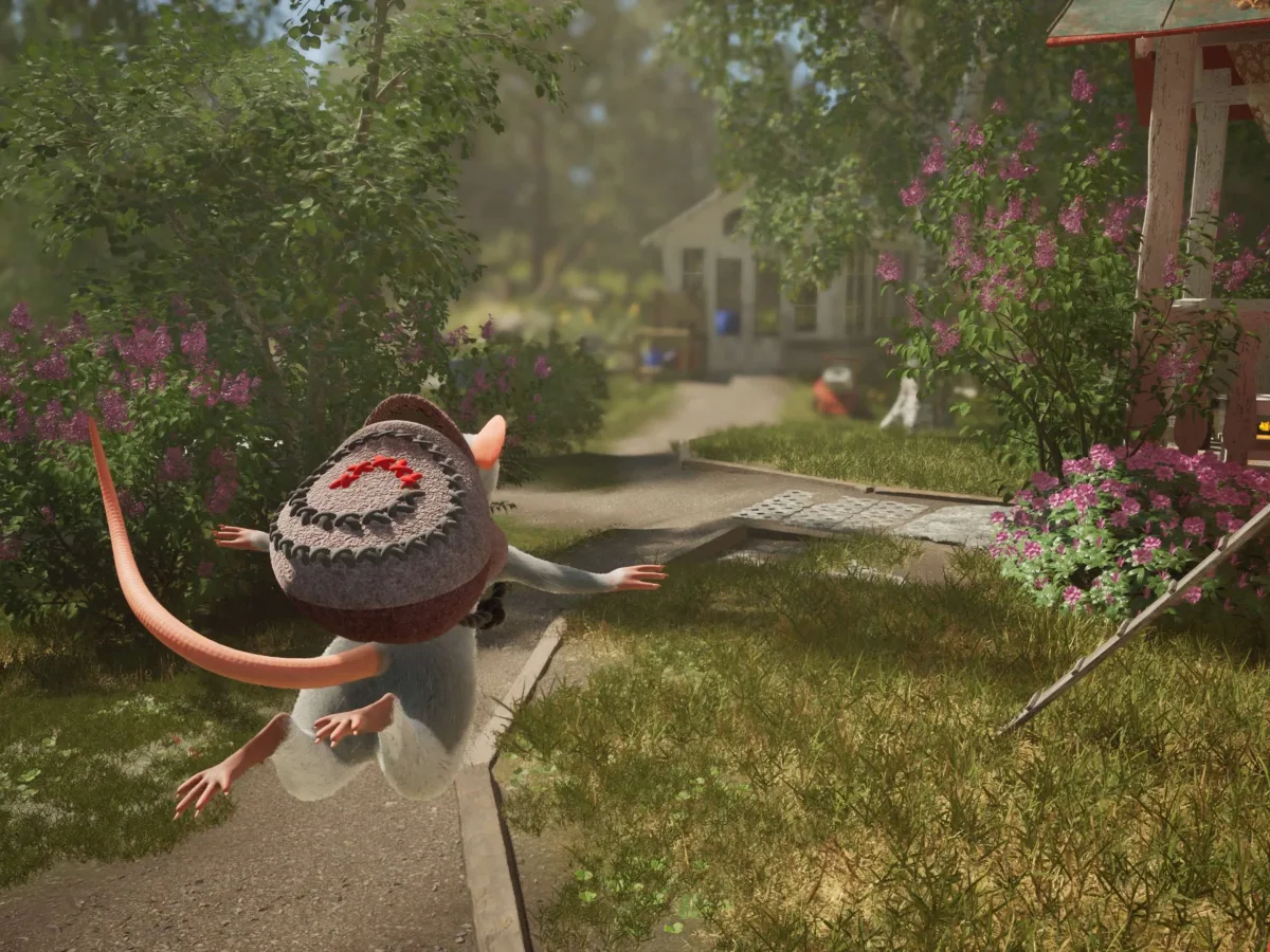 A small mouse wearing a stitched backpack jumps through a garden beside a cottage.