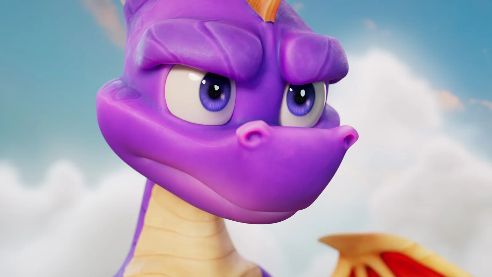 Spyro flies above a bright fantasy landscape of cliffs, trees and stone ruins.