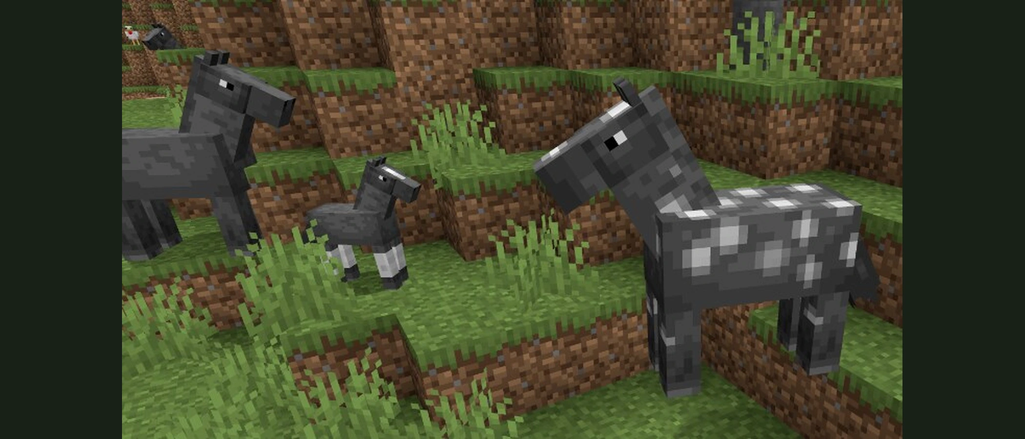 Minecraft horses stand together on grass beside a young foal