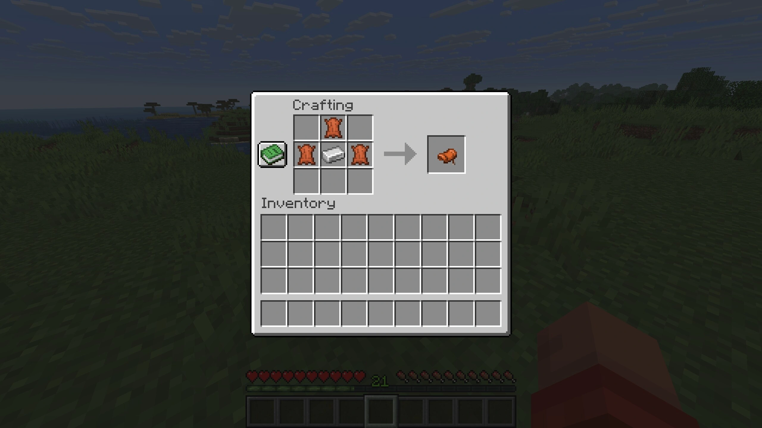 Minecraft crafting grid shows Leather above and either side of one Iron Ingot, with a Saddle in the output