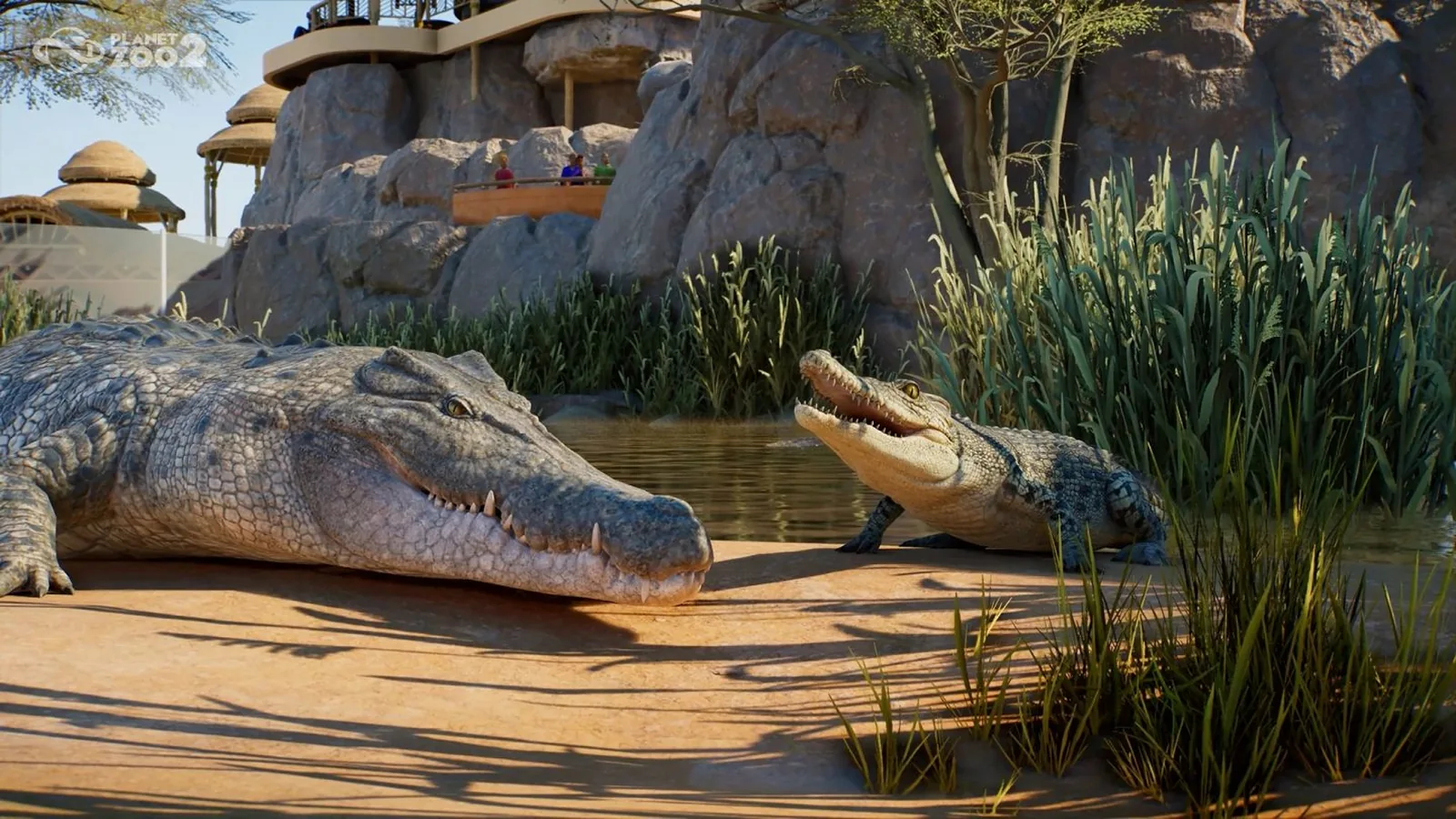 Two crocodiles rest beside water in a planted Planet Zoo 2 habitat.