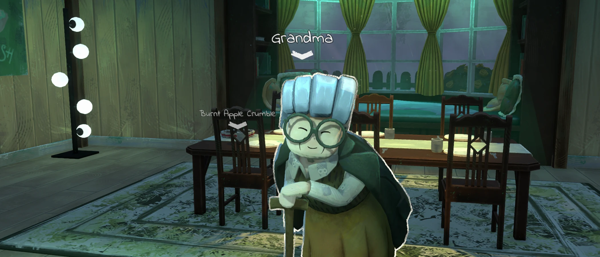 Grandma stands with her walking stick beside the dining table in Apple Crumble.