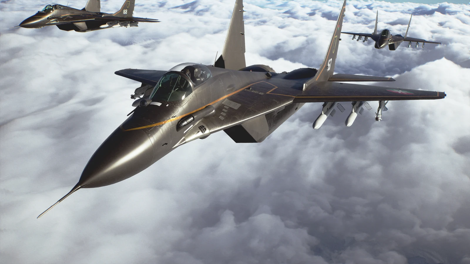 Fighter jets fly together above a bank of white clouds