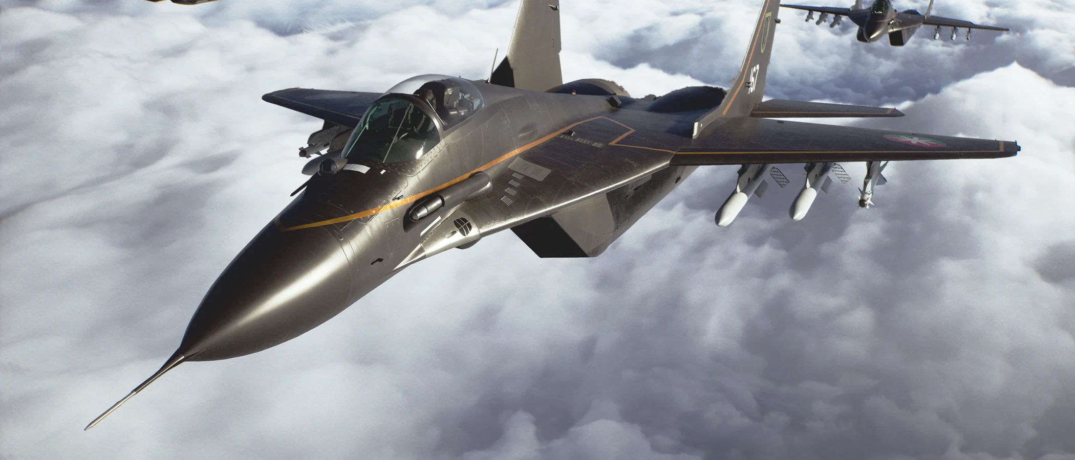 Fighter jets fly together above a bank of white clouds