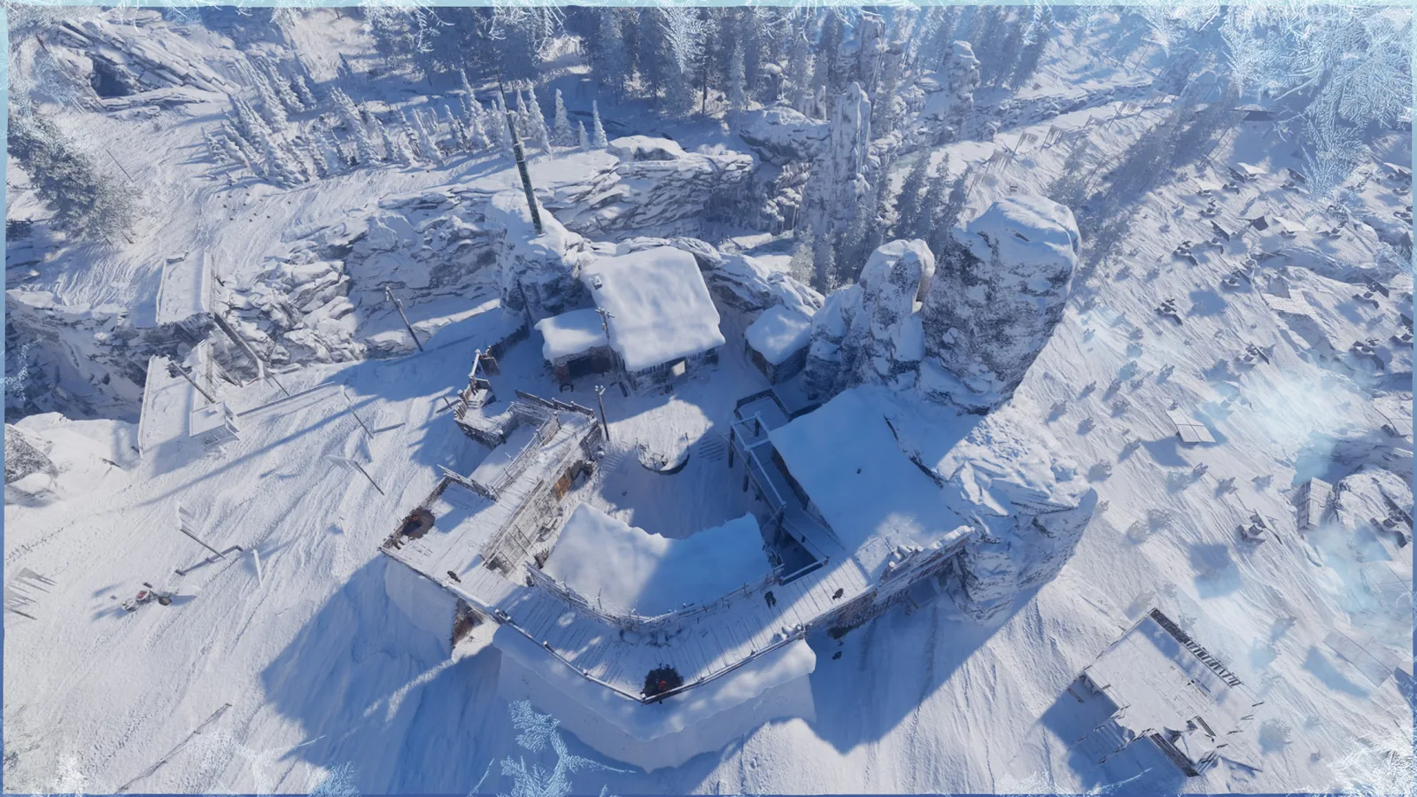 Horizon settlement buildings form a sheltered compound among snowy cliffs