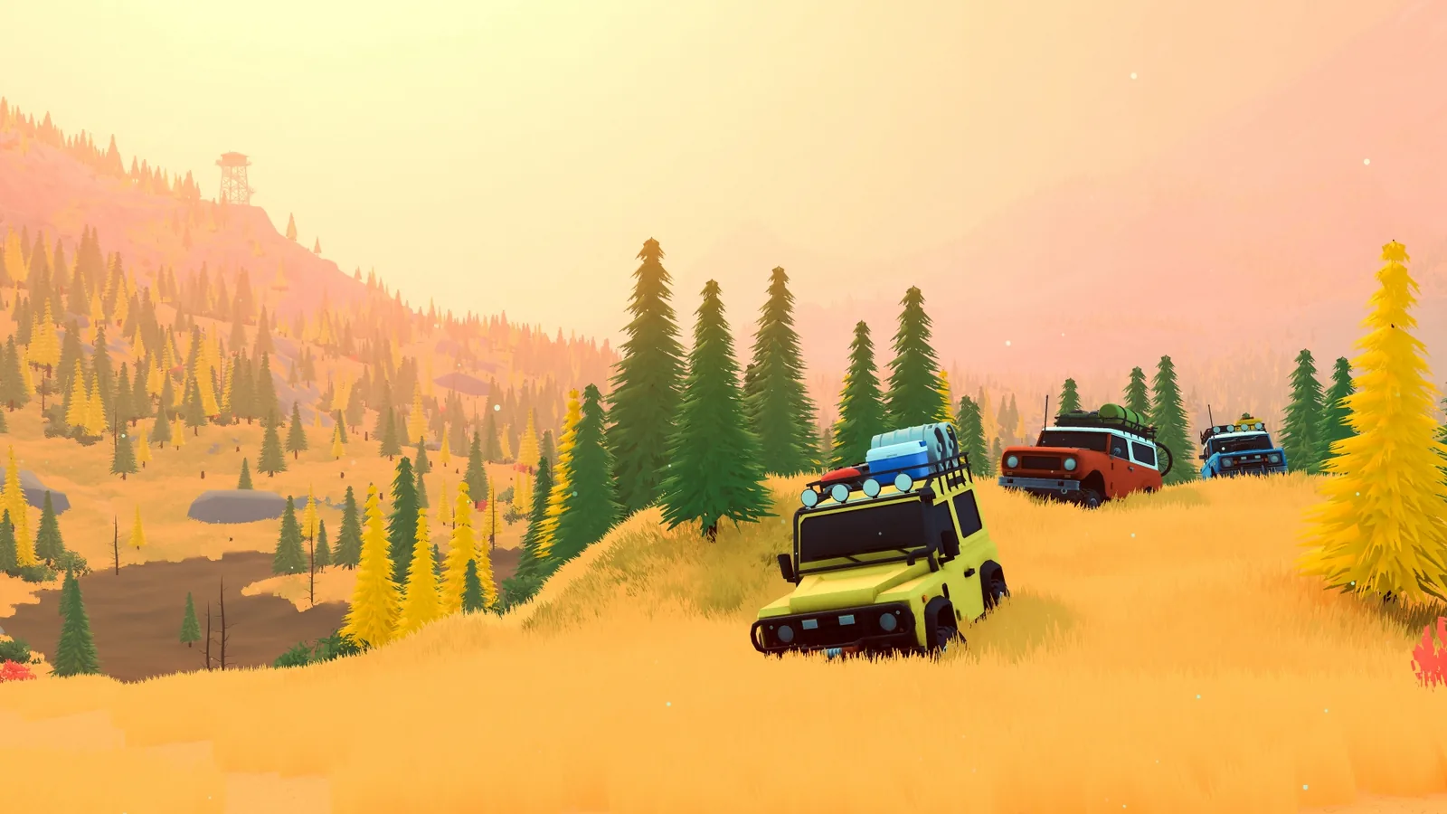 Four off-road vehicles descend a grassy slope in over the hill