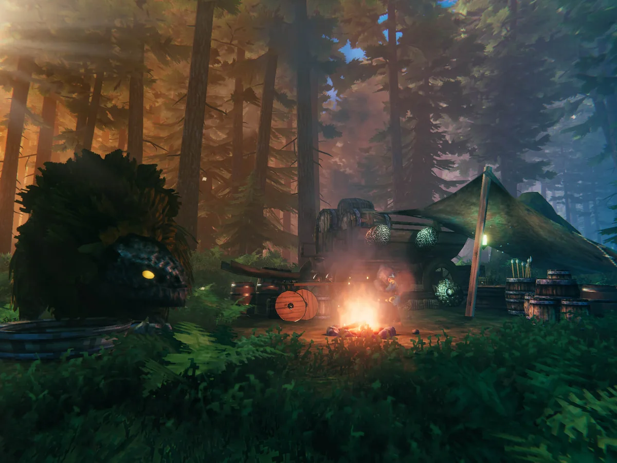 Haldor sits beside a fire at his merchant camp in Valheim's Black Forest, with a lox and tent nearby.